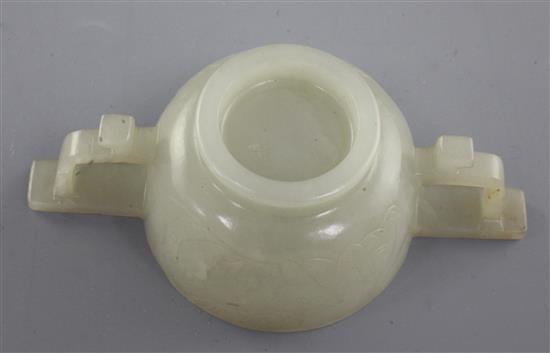 A Chinese pale celadon jade two handled cup, 17th / 18th century, 10.3cm
